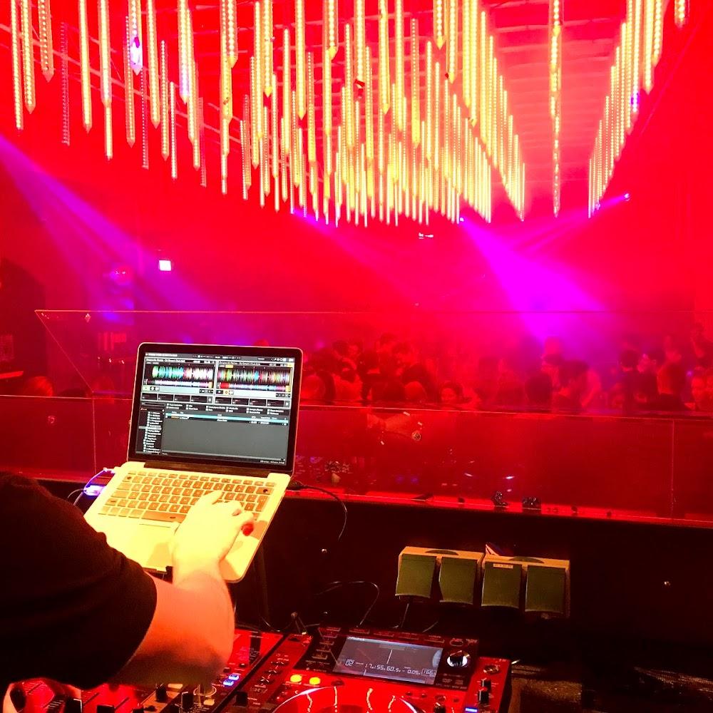 A DJ mixing music in a nightclub.